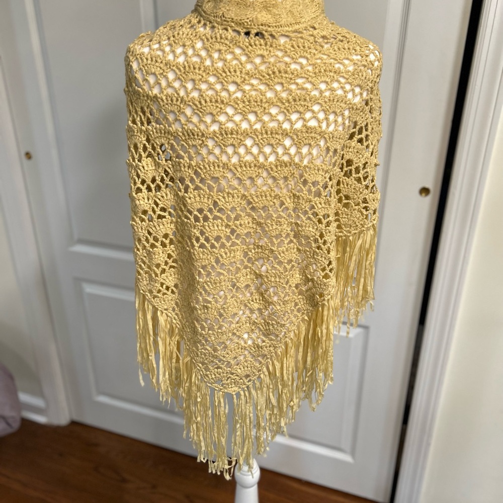 Cejan crocheted poncho in tan. It is one size fits all.
